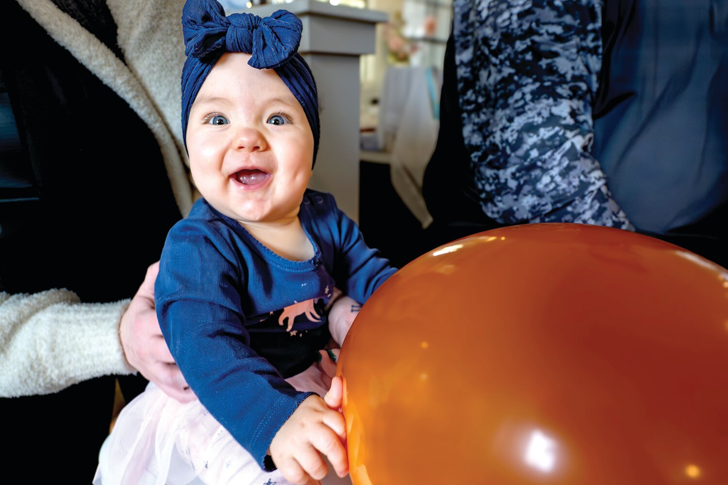 Betty Taylor reaches for a big, orange balloon.