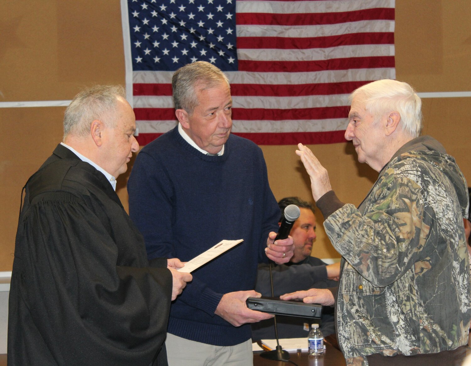 District Judge John Galloway administers the oath of office to auditor Richard Spickler while Falls Supervisor Brian Galloway holds the Bible.