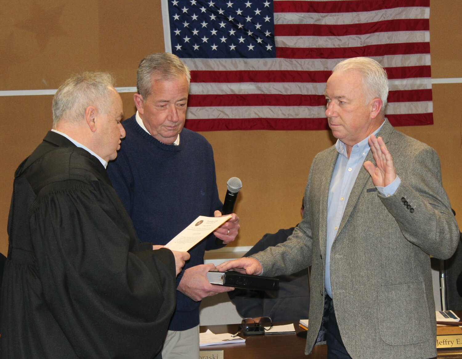 District Judge John Galloway administers the oath of office to auditor Sean Murphy while Falls Supervisor Brian Galloway holds the Bible.