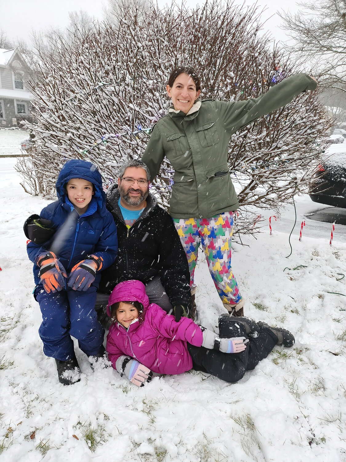 Nina and Justin Jarrah play in the snow with their kids, Silas and Sadie.