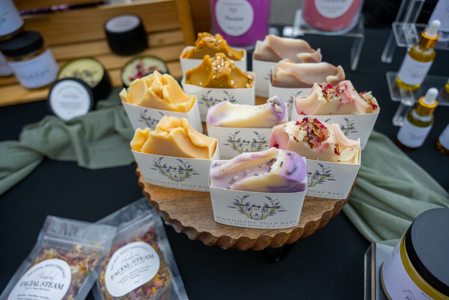 Natural Body Essentials sells handmade soap bars at the market.