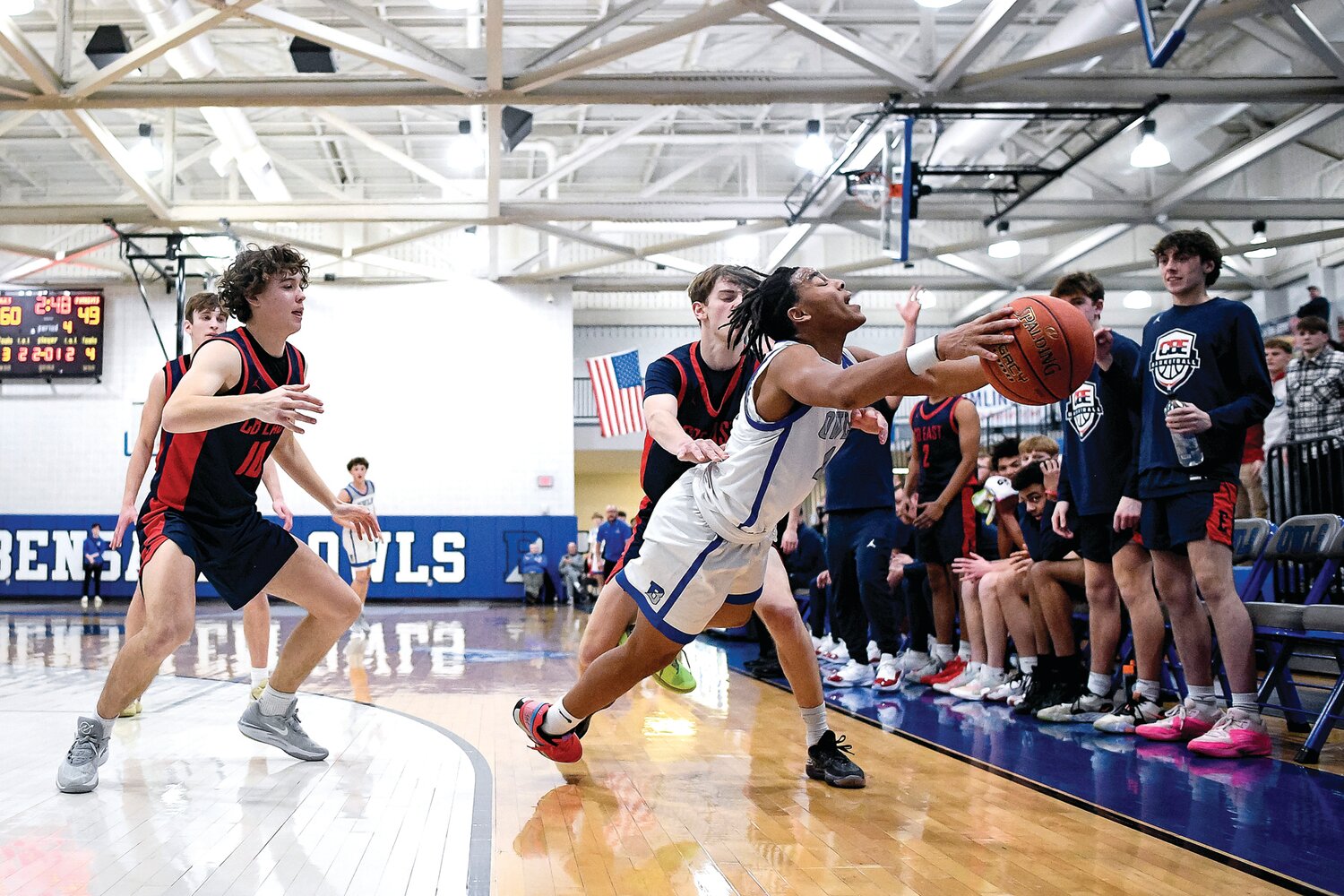 Bensalem’s Amir Drummond dives to save an inbound pass in front of Central Bucks East’s Miles Demby and Bryce Lolas.