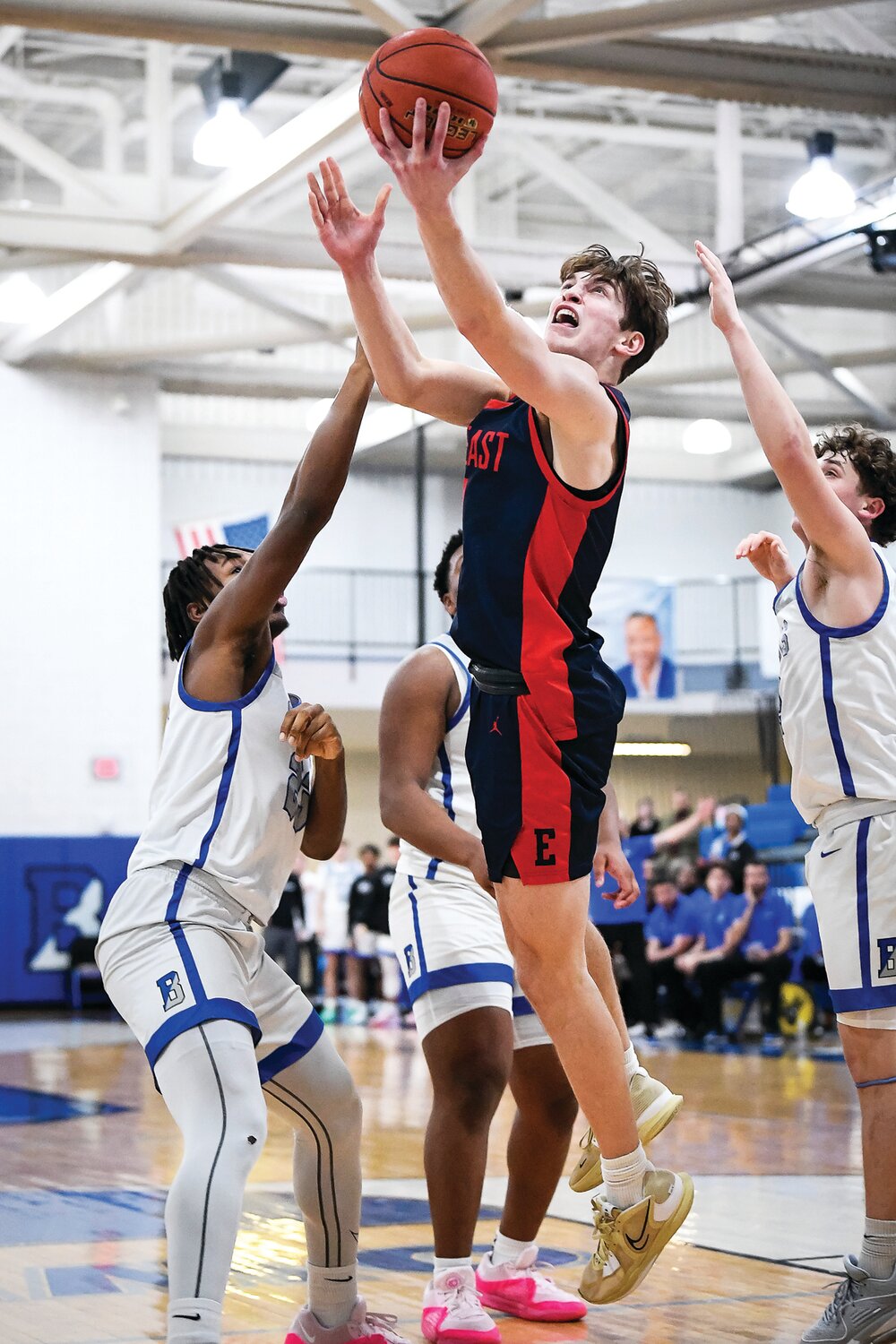 Central Bucks East’s Jacob Cummiskey splits the lane for a layup.