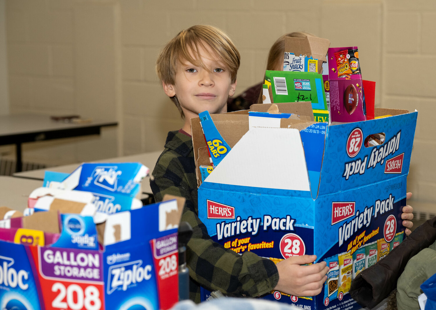 Volunteer Ethan Hivner gathers recyclables at the tail end of Monday’s project.