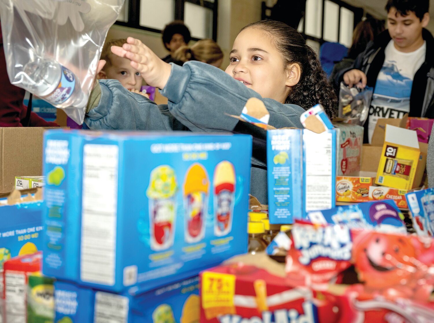 A child takes part in Monday morning’s service project at Our Lady of Grace Catholic School.