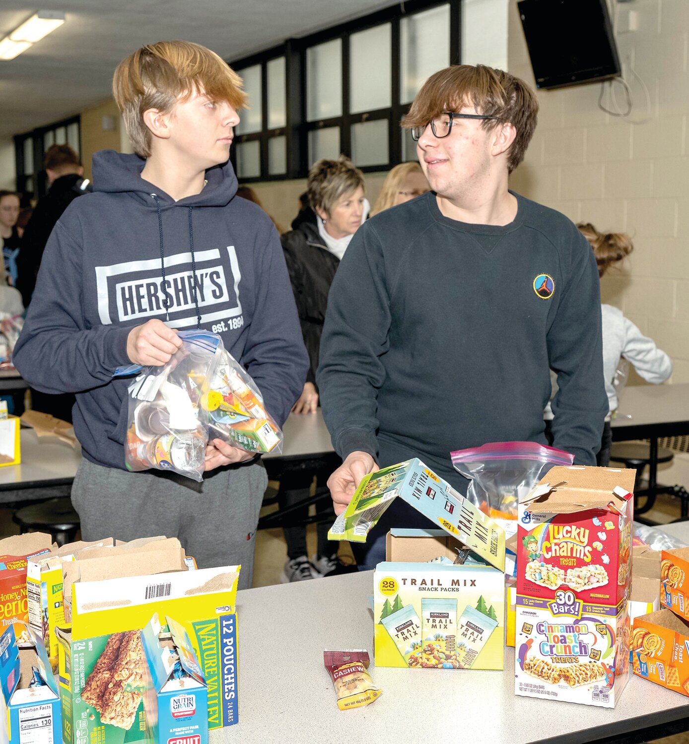 Edmond Darringtun, left, and Jacob Marks pack bags.