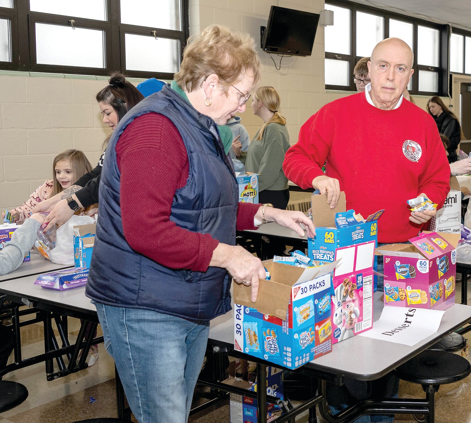 Volunteers Sue and Bob Griggs work at the dessert table.