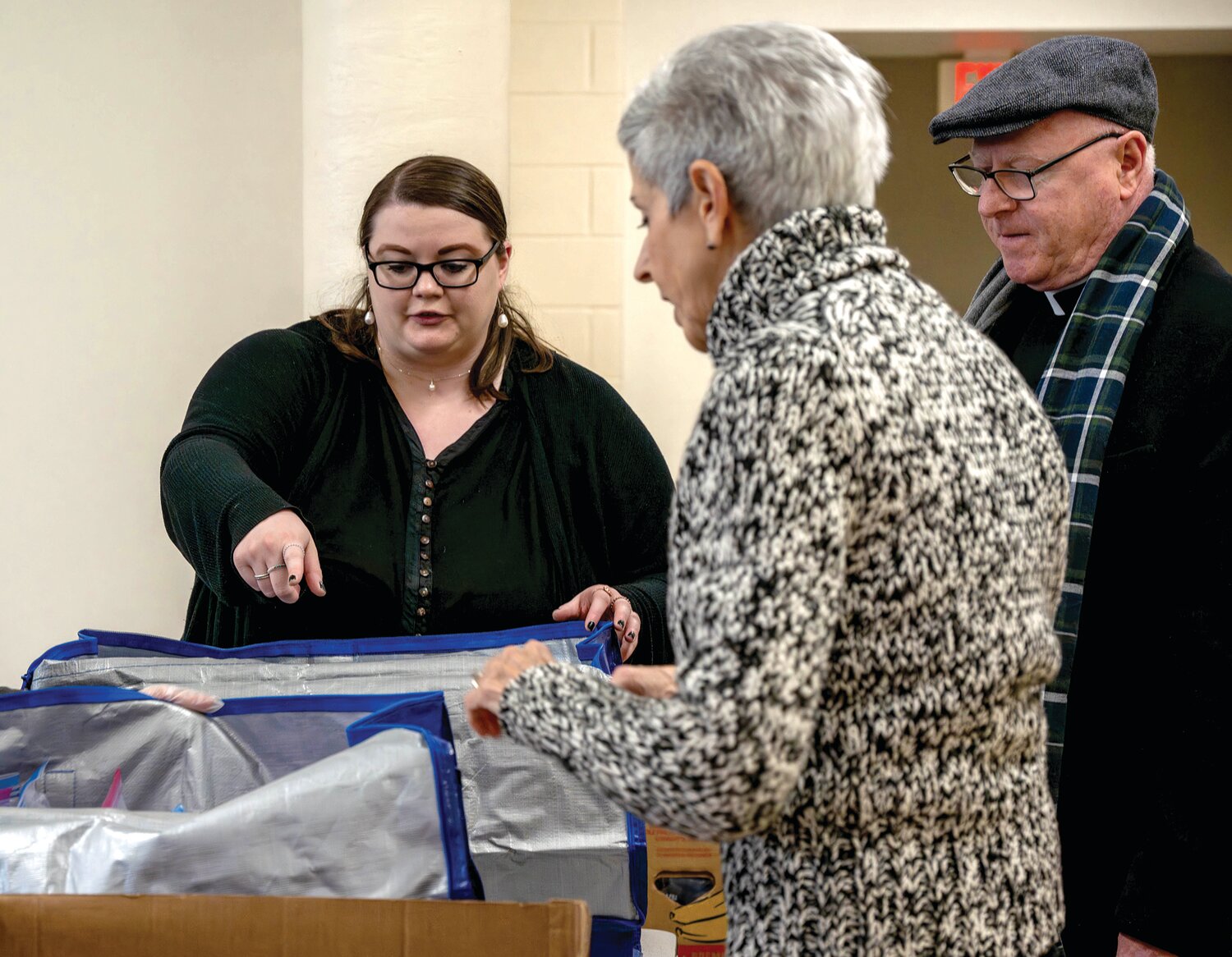 Our Lady of Grace pastoral associate Maddie Appleby fields questions from Barb Higman and Monsignor Joseph Prior, pastor of the parish.