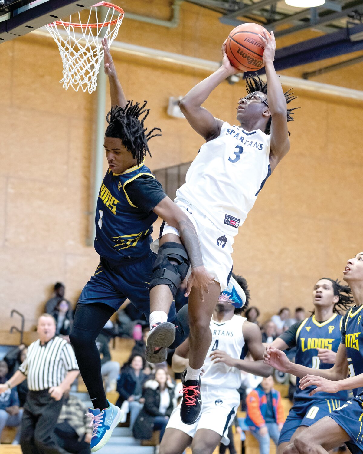 Solebury’s Ari Johnson slices around City’s Hawkins for a 2-pointer.