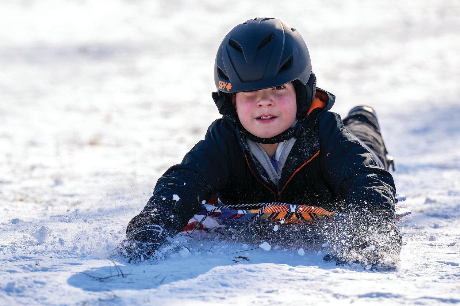 A child goes sledding at Magill’s Hill Park in Solebury.