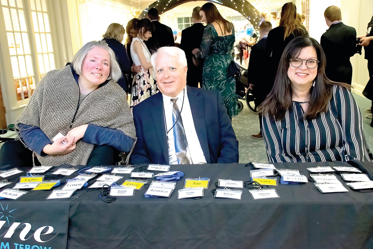 Tina Murphy, Dave Adams and Evelyn Kattan Lucas volunteer at the red carpet claim check-in.