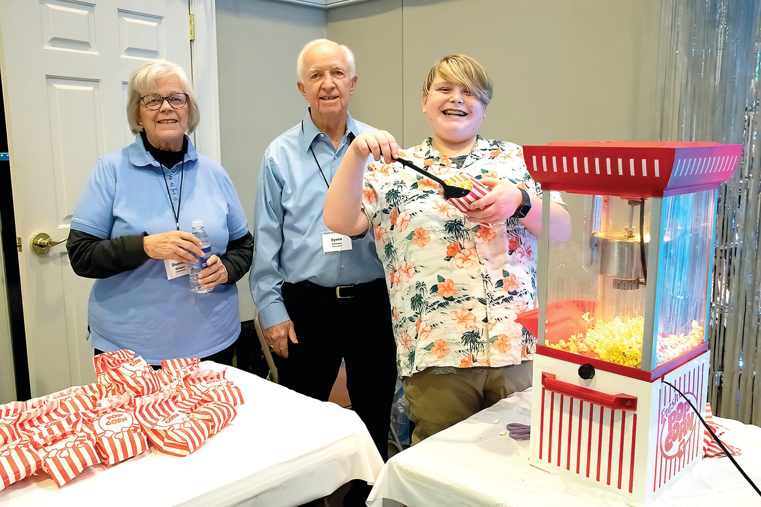 Dorothy and Byron Rimmer, food servers, and Micah Kapusta, a popcorn server.