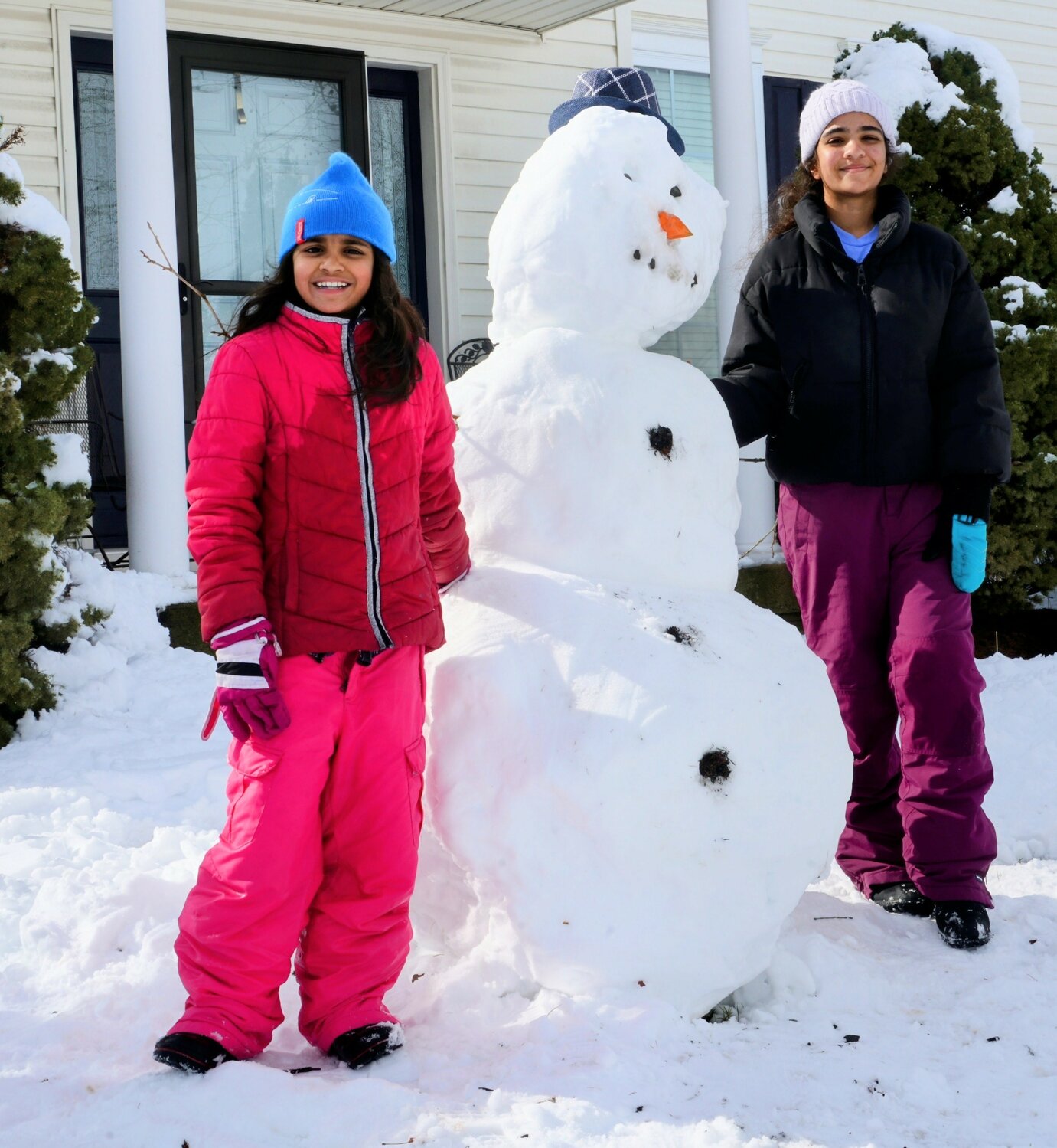 Tuesday’s winter storm dropped heavy, wet snow that was ideal for building a snowman. Annie and Elizabeth, of New Hope, do just that.