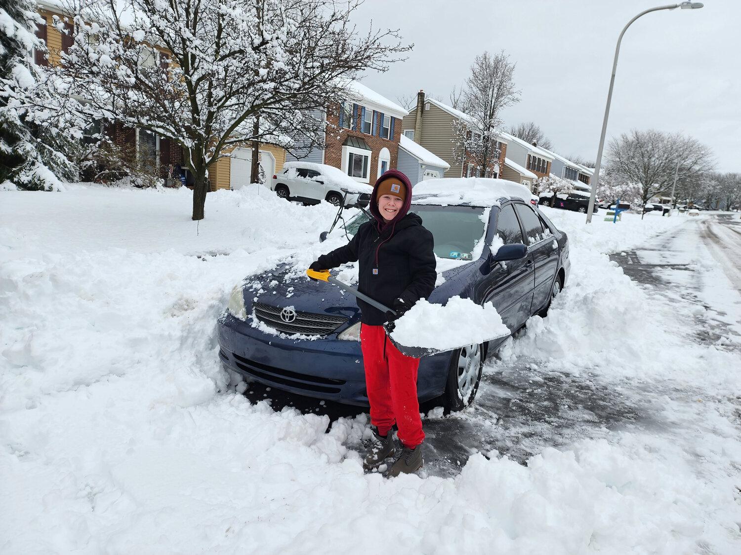 Nicole Lewis, graduating this year, had a smile on her face as she dug her car out from the snow storm.