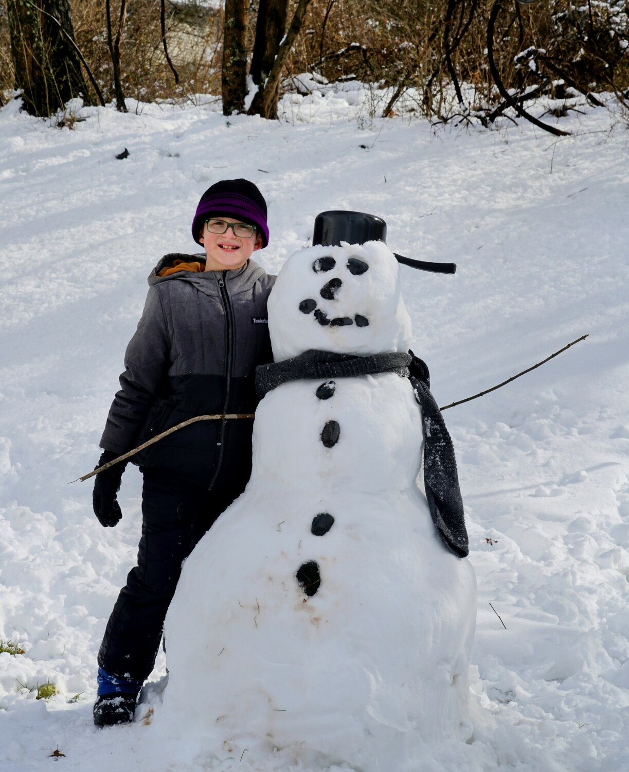 Jace, from New Hope, poses with his snowman Tuesday.