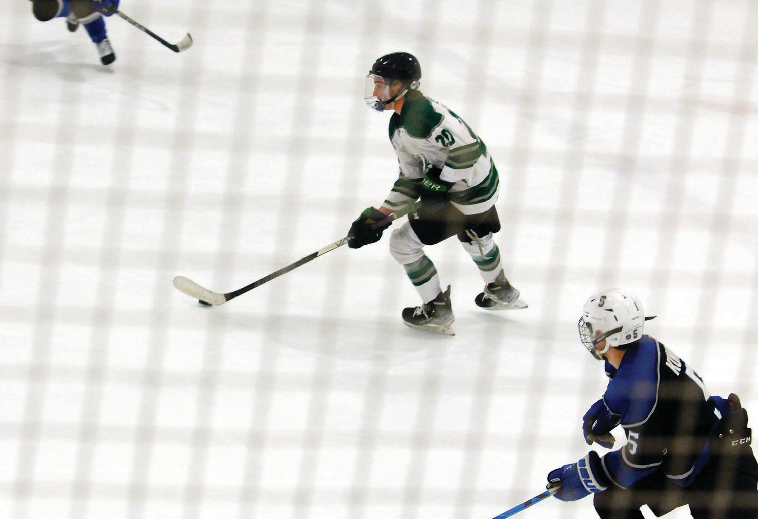 Pennridge’s Kevin Pico takes the puck up ice in battle against CB South Feb. 14 at Hatfield Ice Arena. Jake Kunkle, right, pursues Pico for the Titans.