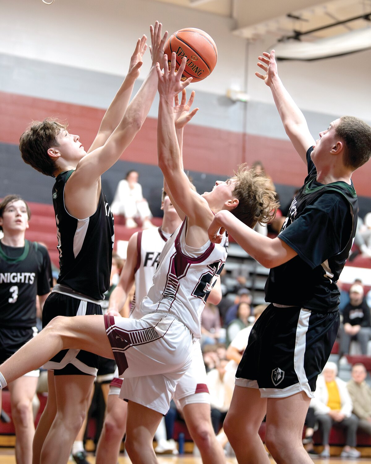 Faith Christian’s Jagger Verbit goes up against Delco Christian’s Cole Pruessner and Bradford Berwick.