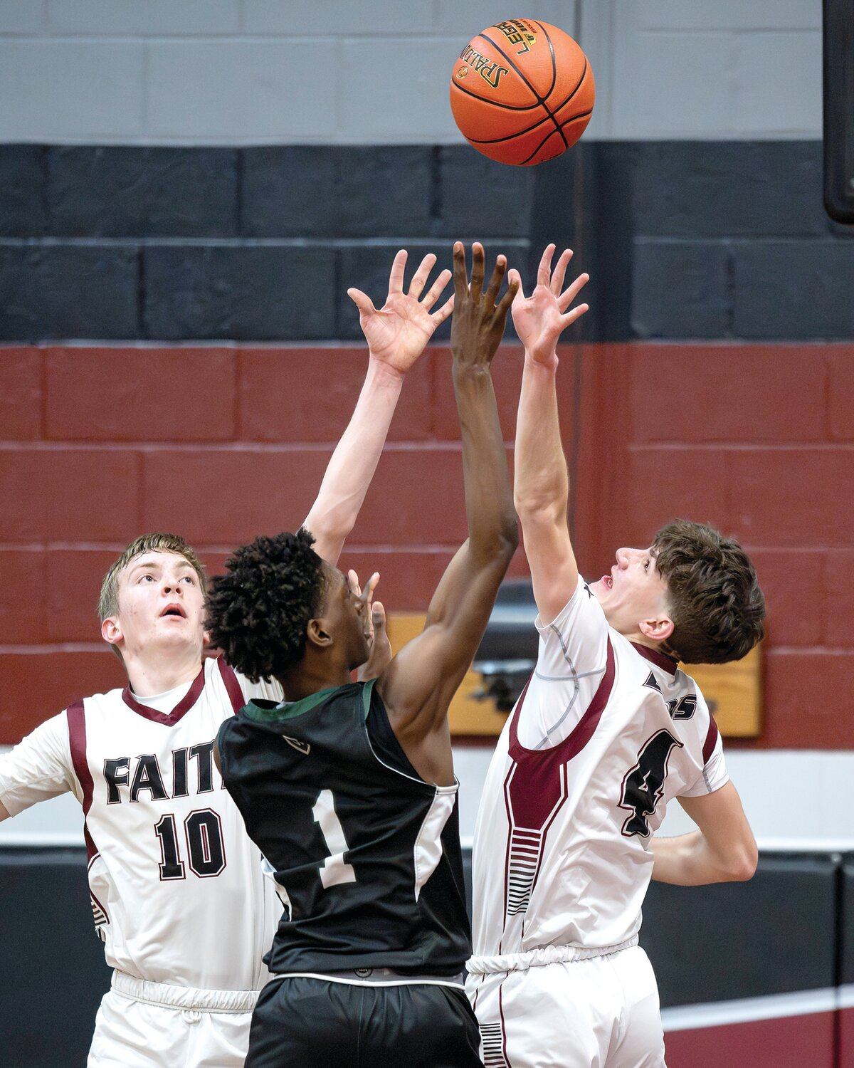 Faith Christian’s Tyler Forscht and Mason Paul go up to block the shot of Delco Christian’s Khamai Orange in the first half.