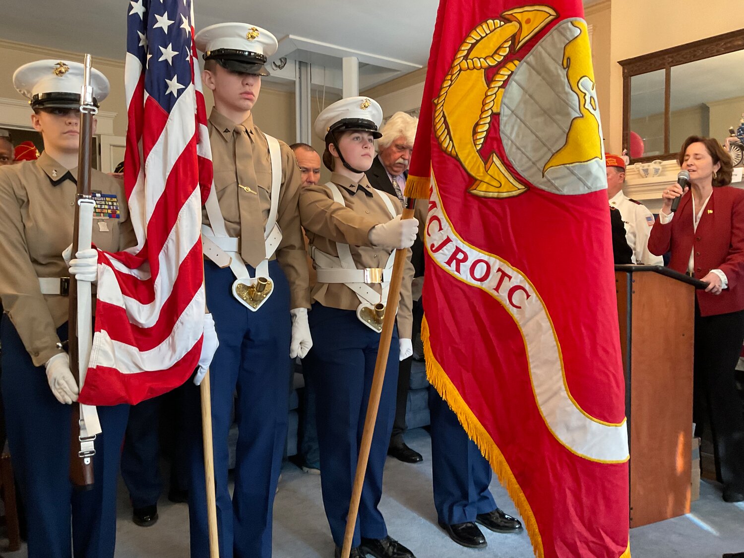 Kay Weeder, of Doylestown, sings the Star-Spangled Banner while the Bensalem High School Jr. ROTC, under the direction of Colonel John Church, perform the color guard ceremony at Sunday’s celebration in Bristol.