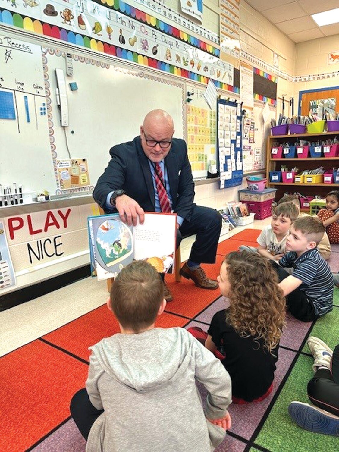 Pennridge School District Superintendent Angelo G. Berrios reads to students at Bedminster Elementary School.