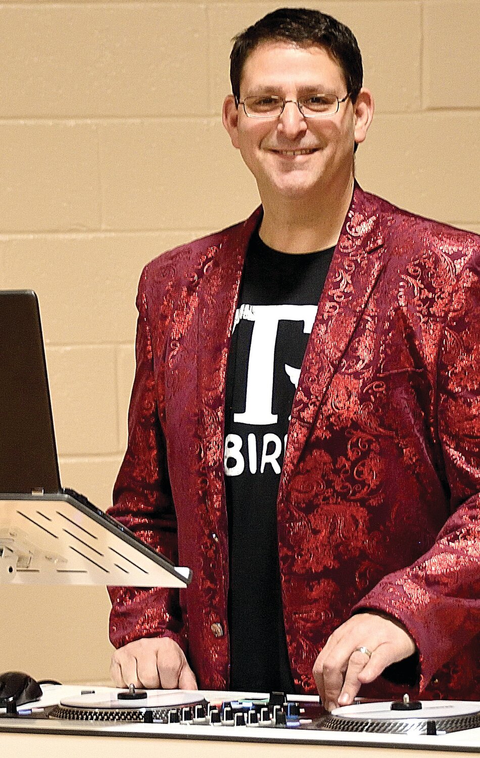 Art Armani acts as disc jockey for the 1950s dance at St. Joseph/St. Robert Catholic School.