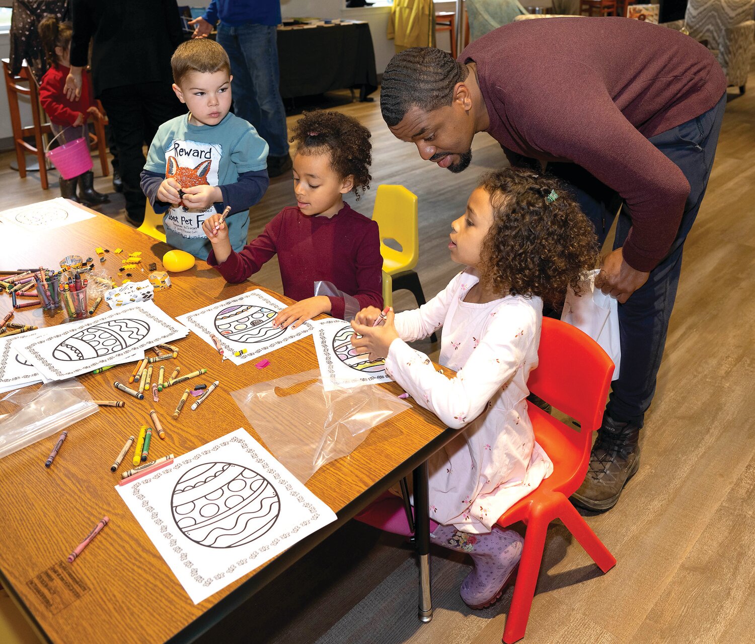 Children color at a table during Saturday’s egg hunt.