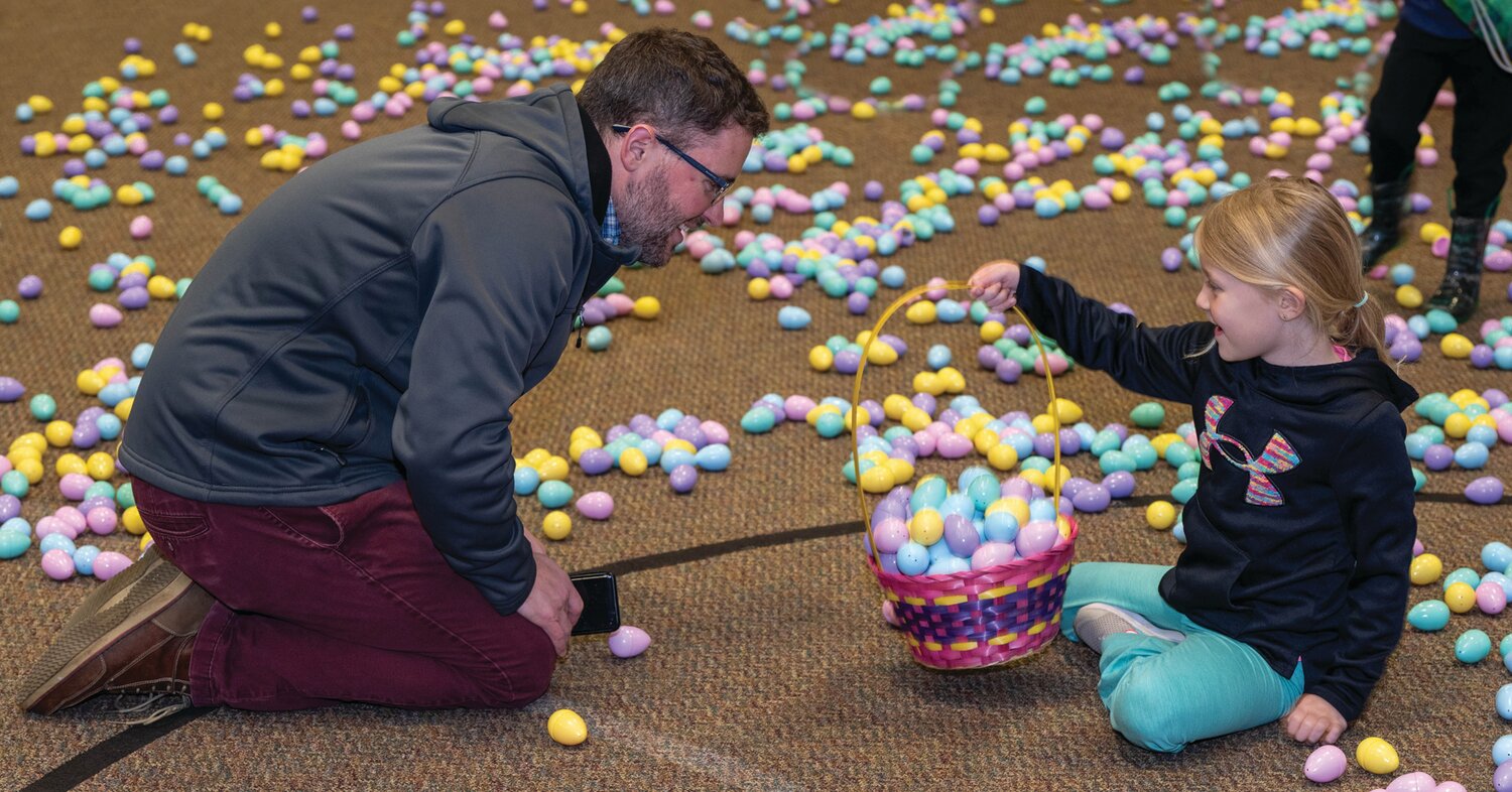 Charlotte Christopher shows her basket to father Kyle.