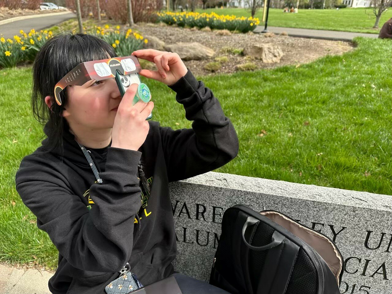 An individual snaps a photo of the eclipse on the Delaware Valley University campus.