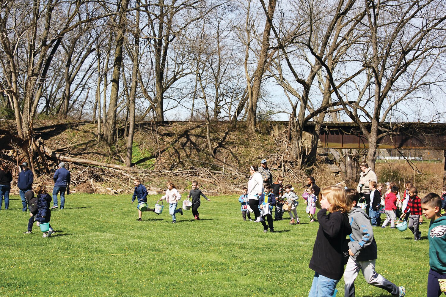 Egg hunters race across the field.