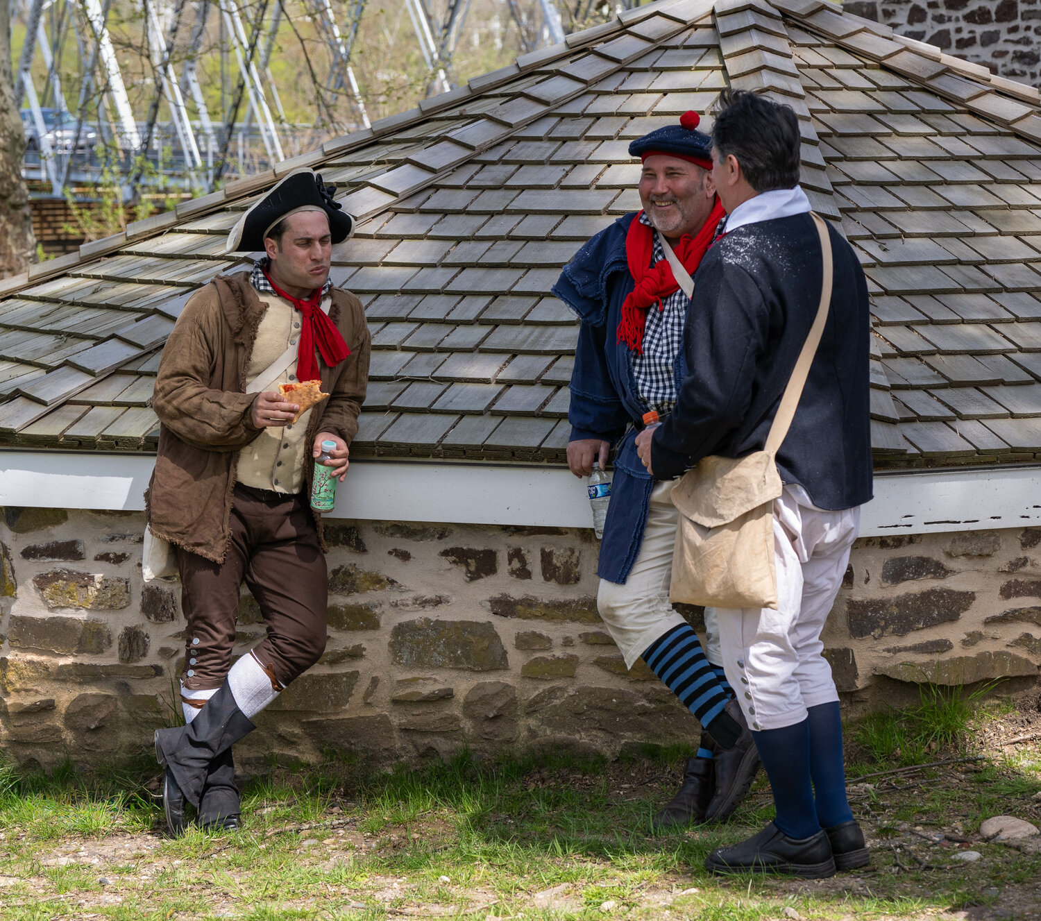 A reenactor has some pizza and an Arizona iced tea during a break in the filming at Washington Crossing Historic Park.