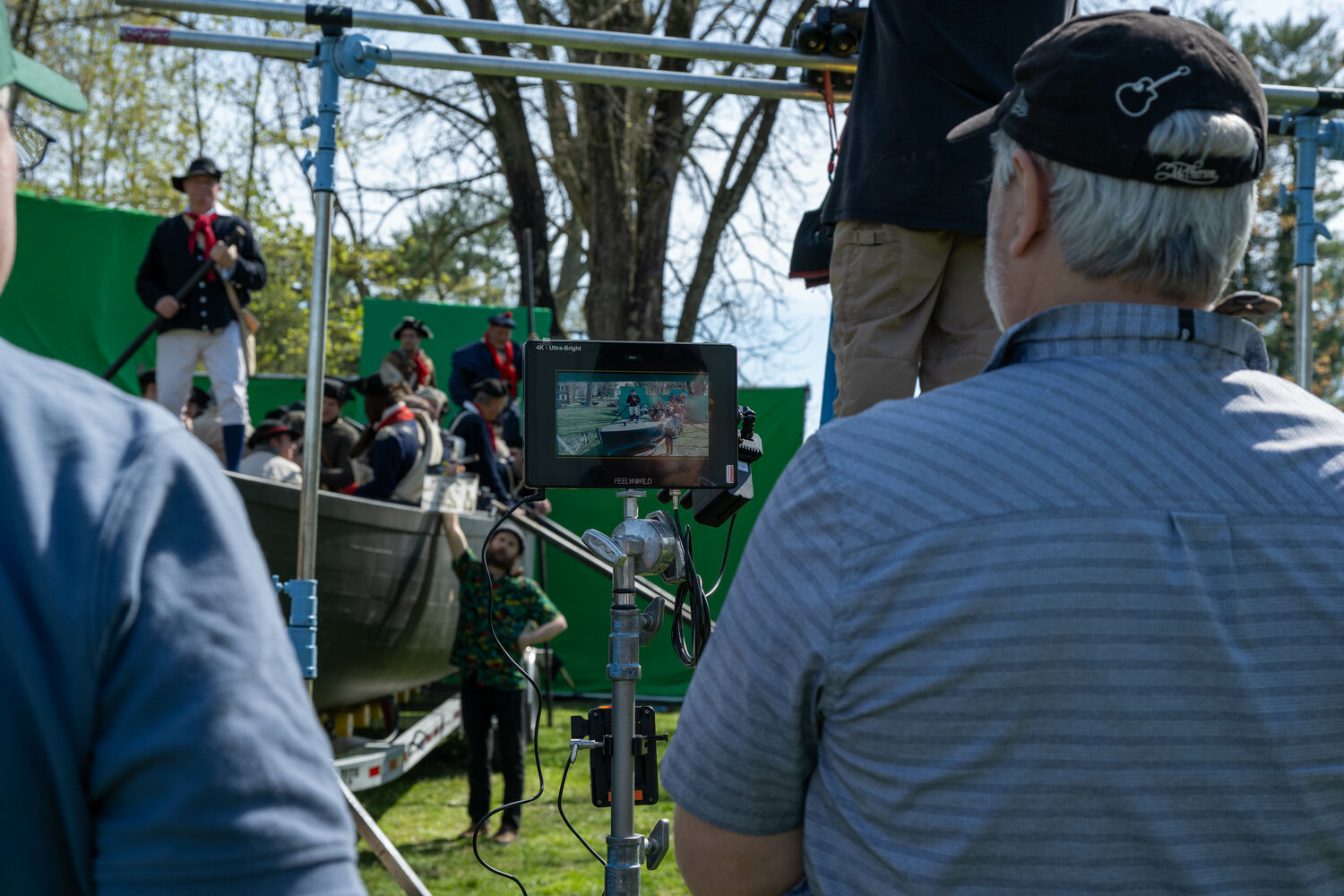 The reenactors shoot a river crossing scene in front of green screens. The river will be digitally added later.