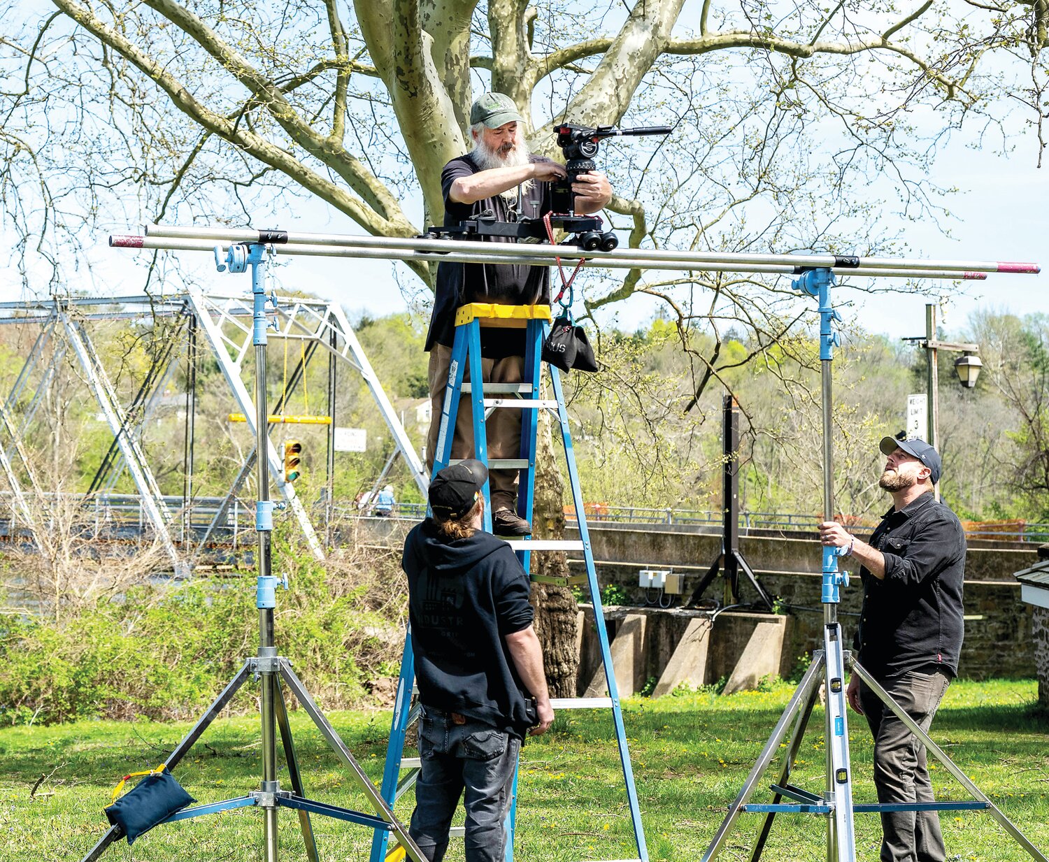 Director of Photography Stephen Lyons positions a camera in an elevated location during shooting.