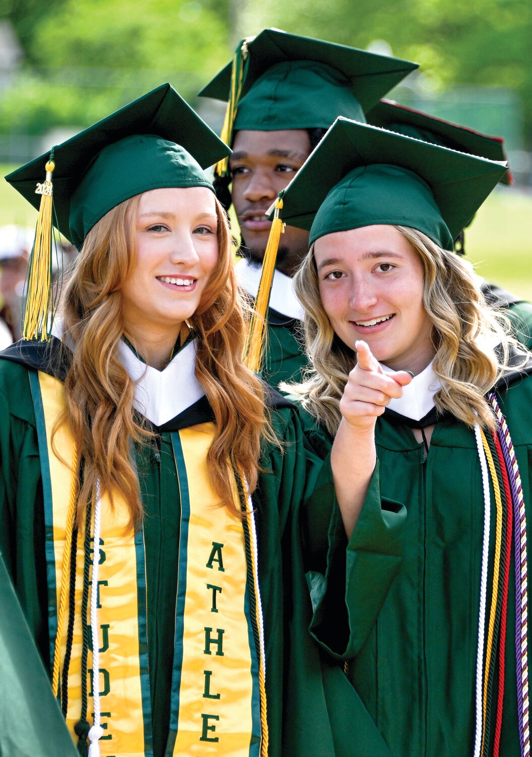 Media majors Marley Bramsway and Emma Monismith prepare to step on stage and pick up their diplomas during the commencement ceremony for the Class of 2024.