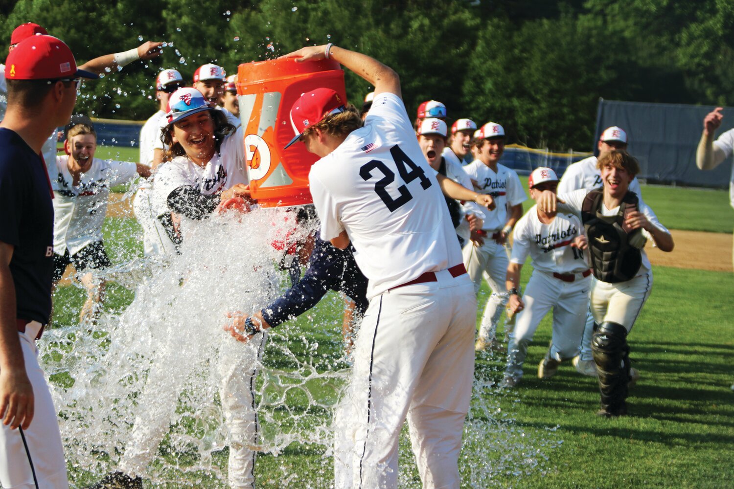 Tim Mahony and Brody Wojnicki shower head coach Kyle Dennis to celebrate Central Bucks East’s Colonial Division title.