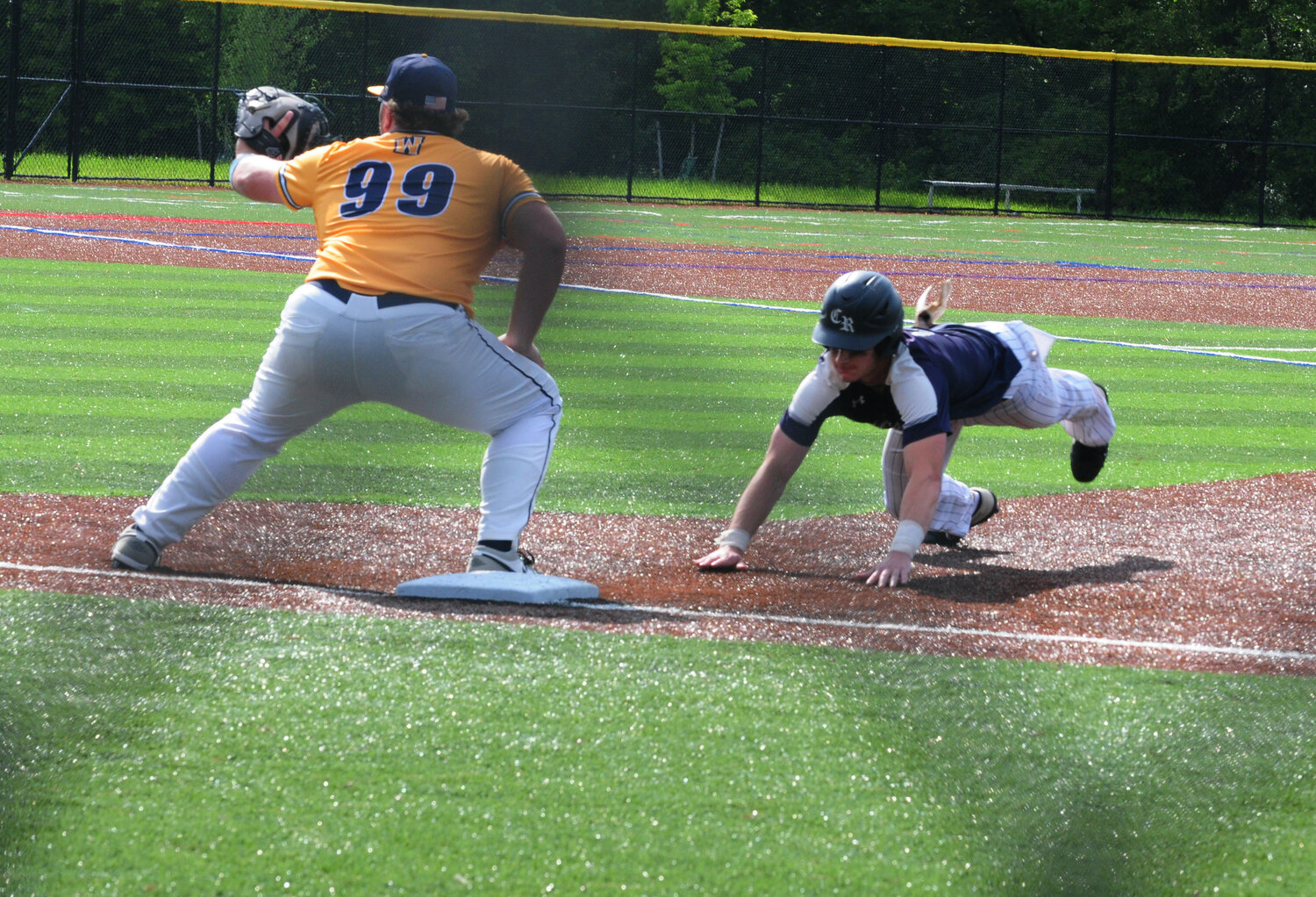 Council Rock North baserunner Nick DiGiacomo scrambles back to first base in Monday’s District One playoff opening loss to Wissahickon. Jarrett Federer covers the bag for the Trojans.