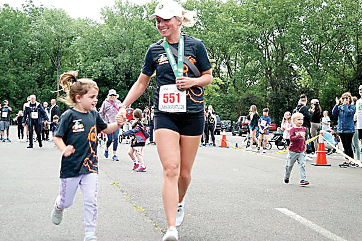 Sara Voong, right, of Broomall, assists her daughter in Sunday’s 24th annual Kiwanis-Herald Sesame Place Classic.