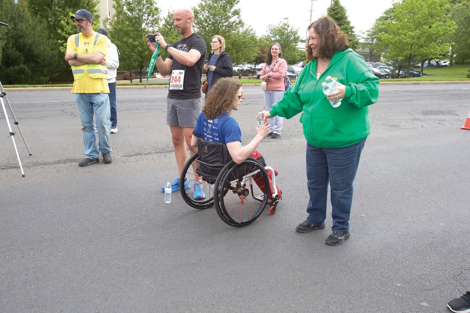 A Sesame Place Classic 5K participant gets a bottle of water after the race.