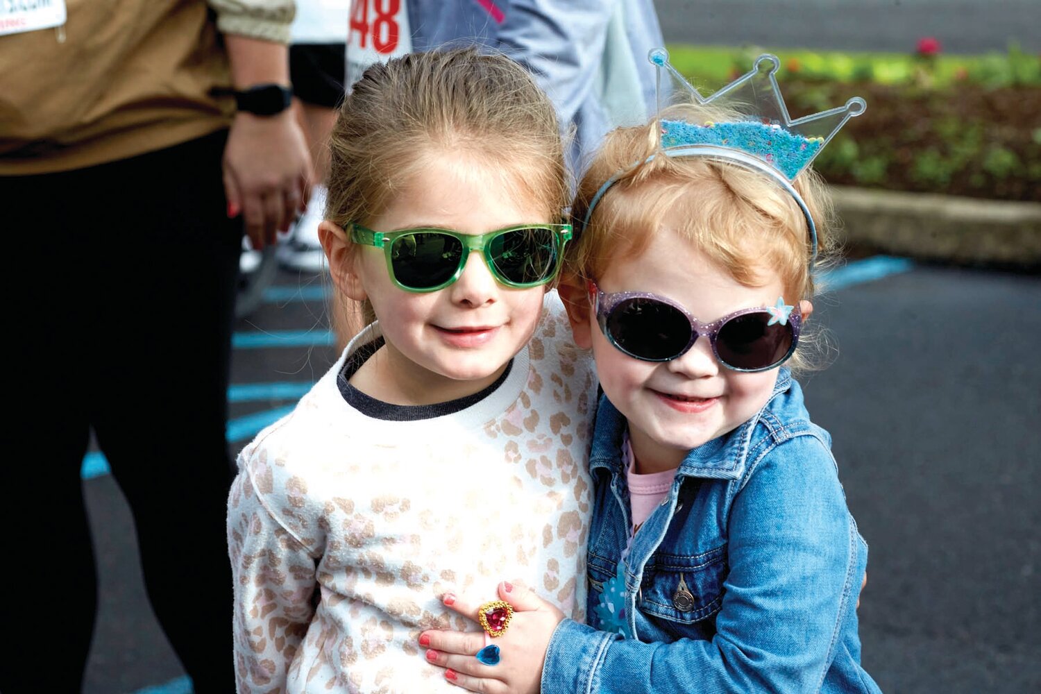 Jules Kelley, 4, and Capri Kisthan, 3, of  Philadelphia wait to see Elmo during the Sesame Place Classic May 19.