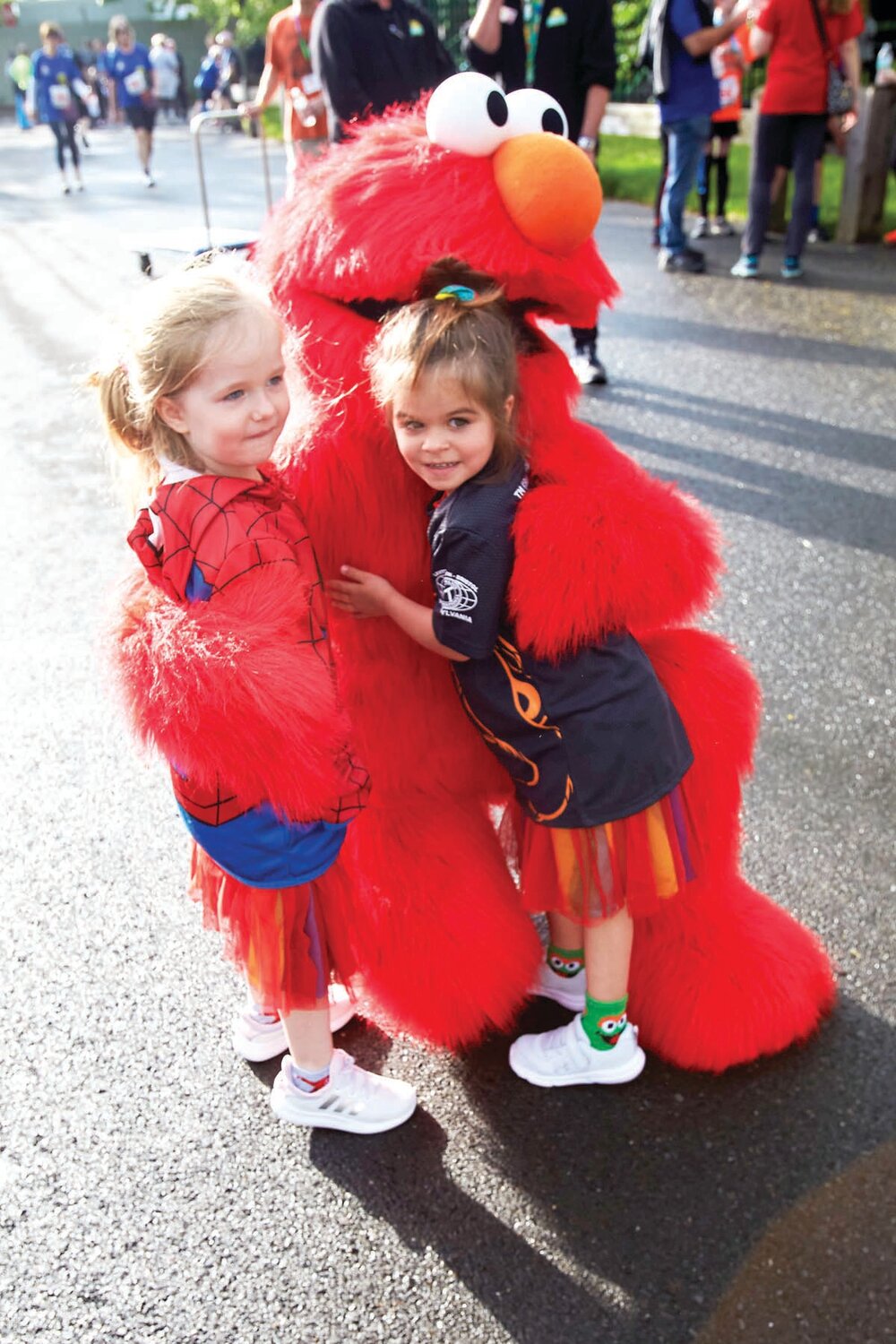 Four-year-old twins Ivey and Lilly McNelly of Green Lane with Elmo.