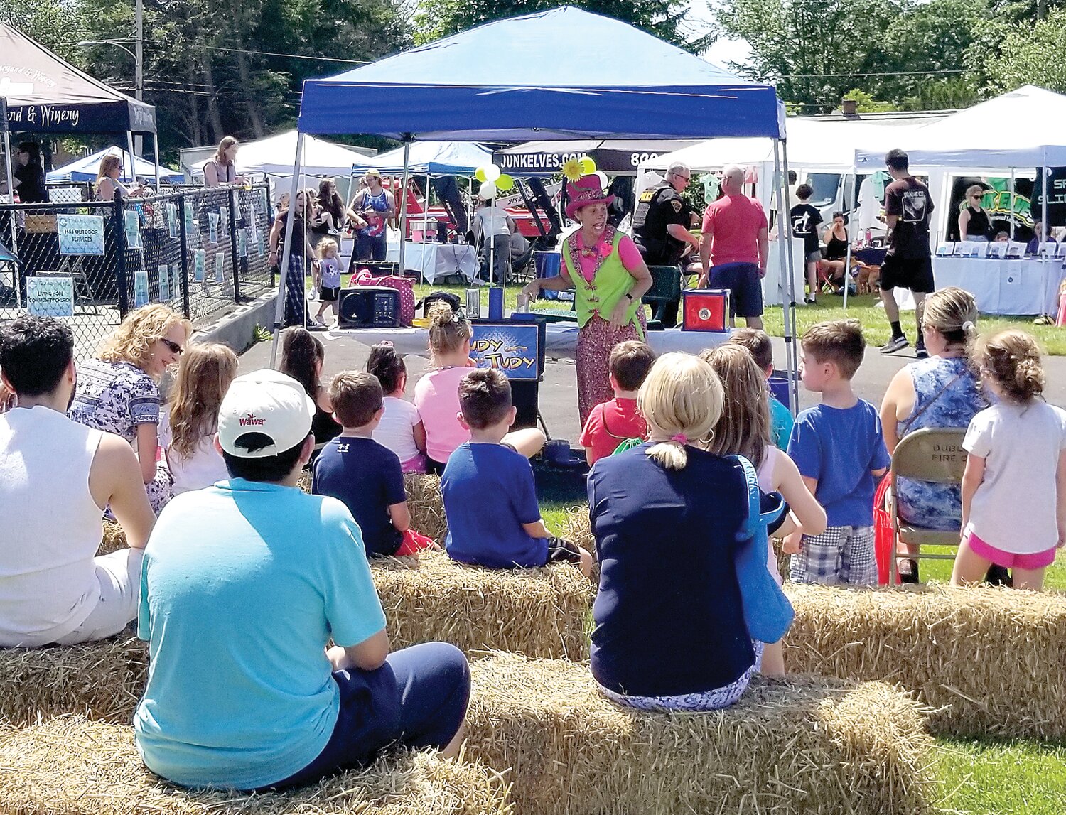 Judy Tudy draws a crowd with her mix of magic and mirth at Dublin Community Day Saturday.