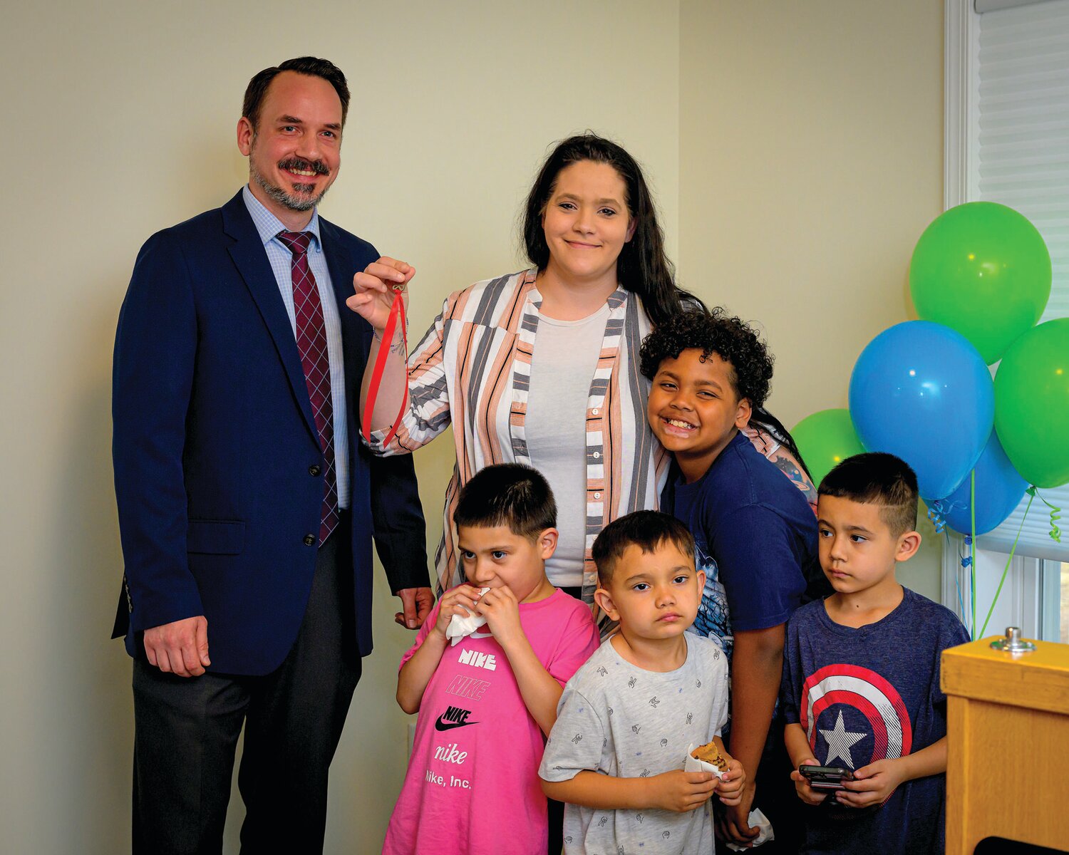 Jeff Darwak, executive director of the Redevelopment Authority, hands over the keys to Angela.