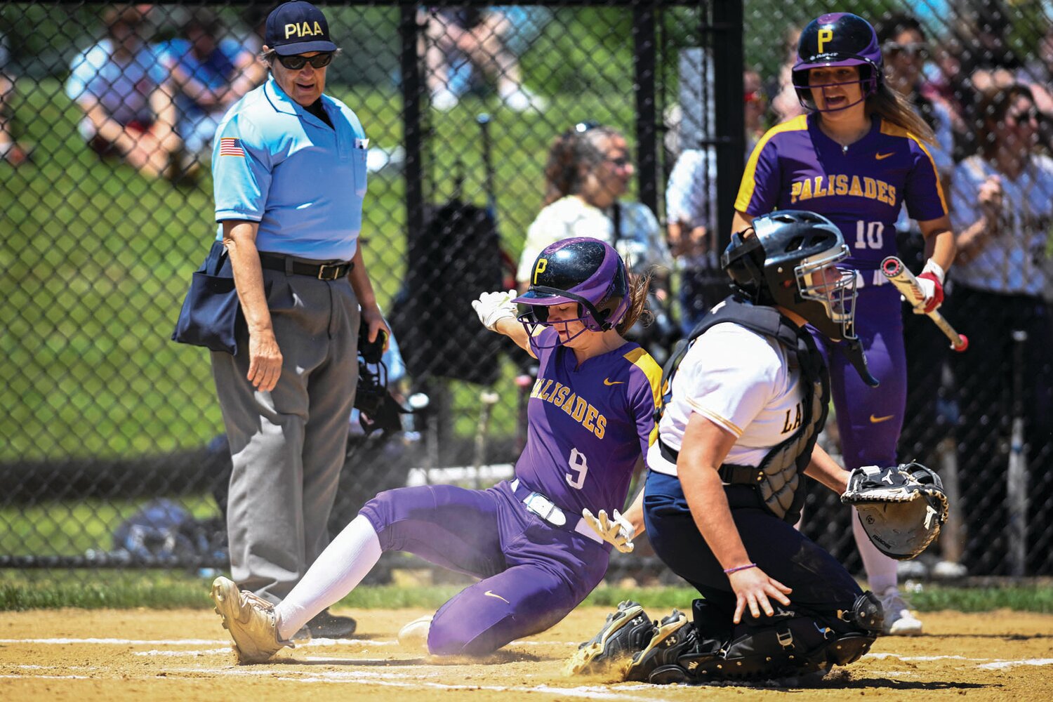 Palisades’ Ailish Kelleher beats the throw to the plate, scoring the first run in Friday’s PIAA play-in game against New Hope-Solebury. The Pirates won 5-4.