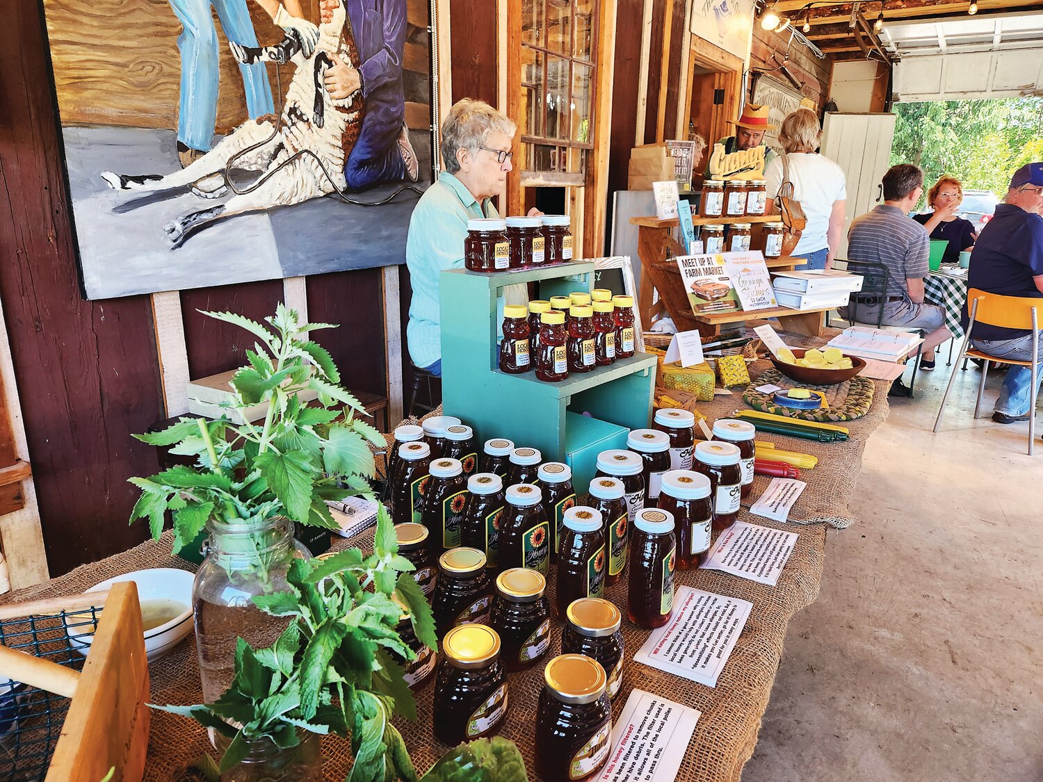 Betsy Wentz sells honey with her husband, Scott Guiser, at the Plumsteadville Grange Farm Market.