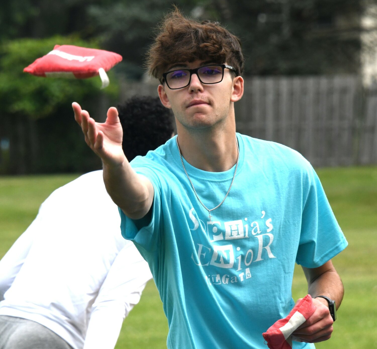 Andrew Leibig, a Bensalem High School senior, plays cornhole with friends during Sophia’s Senior Tailgate.