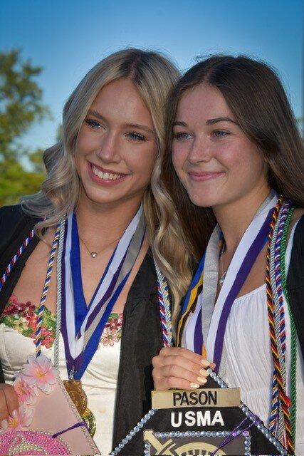 Kaylei Gruver and Holly Pason take a second to pose for a photograph.