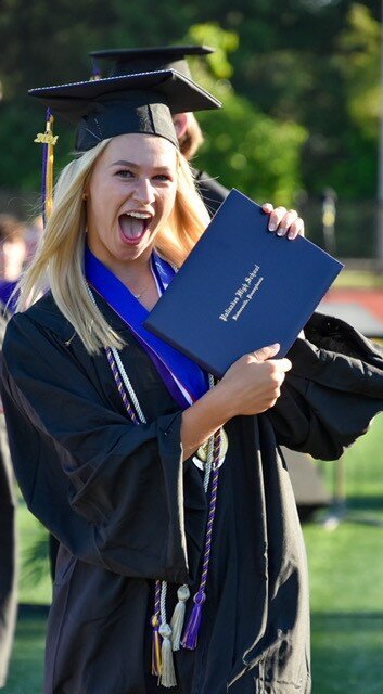 Chesney Mosher shows off her diploma.