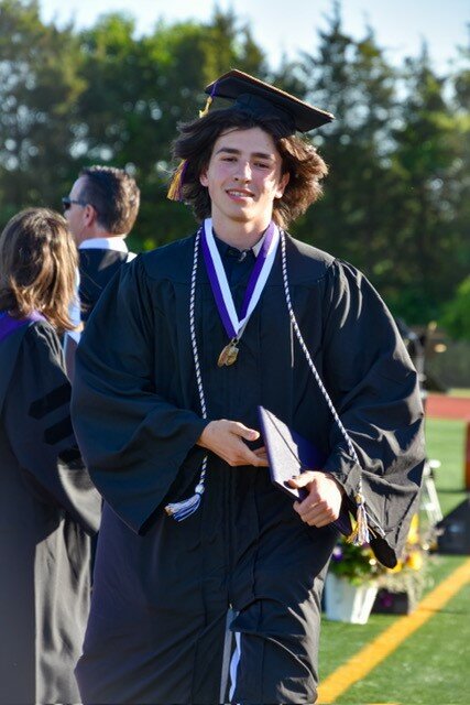 Aidan Nokhoudian returns to his seat after picking up his diploma.