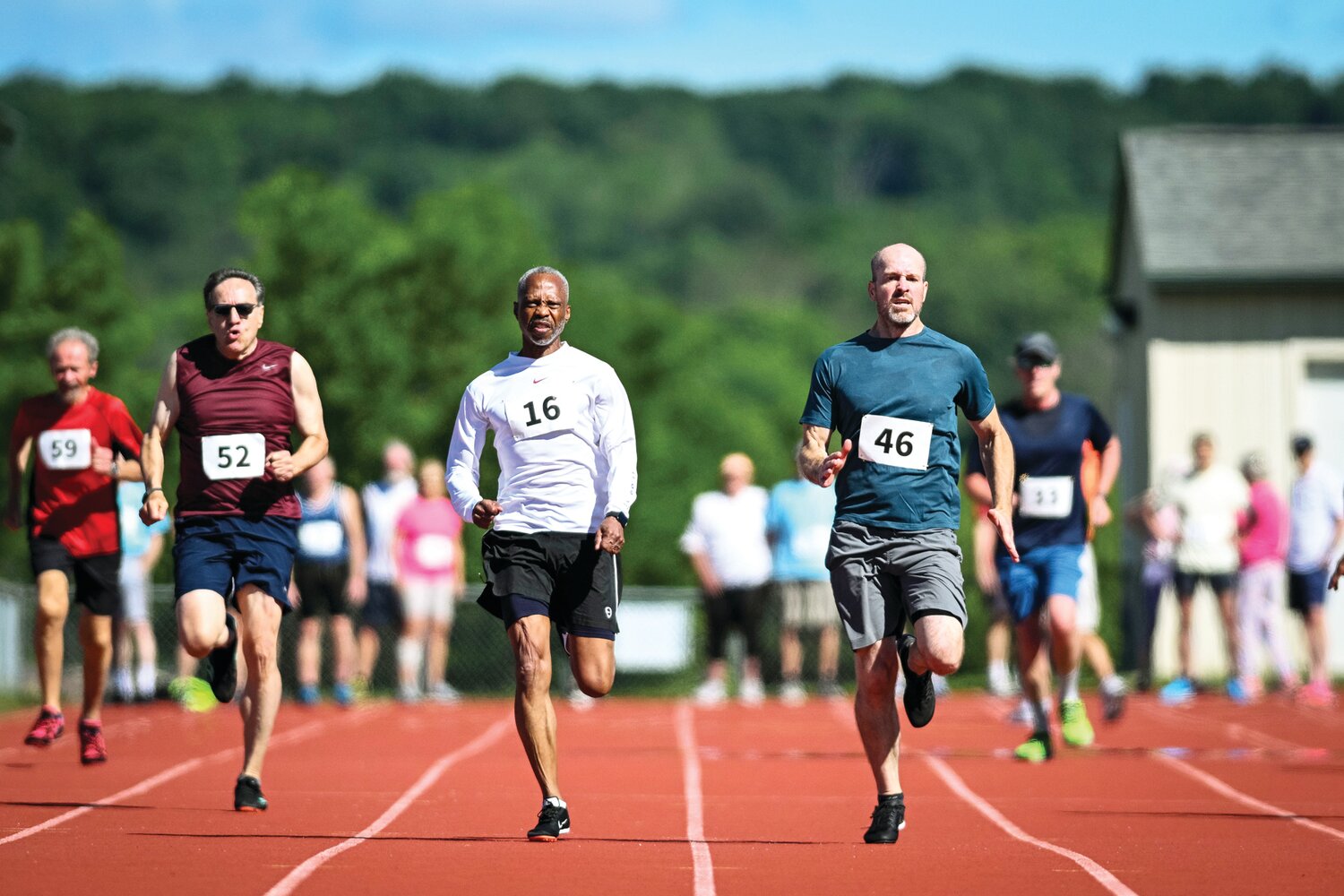 Gerry Bennett, center, and Brian Fitting were neck and neck during the 100-meter dash.