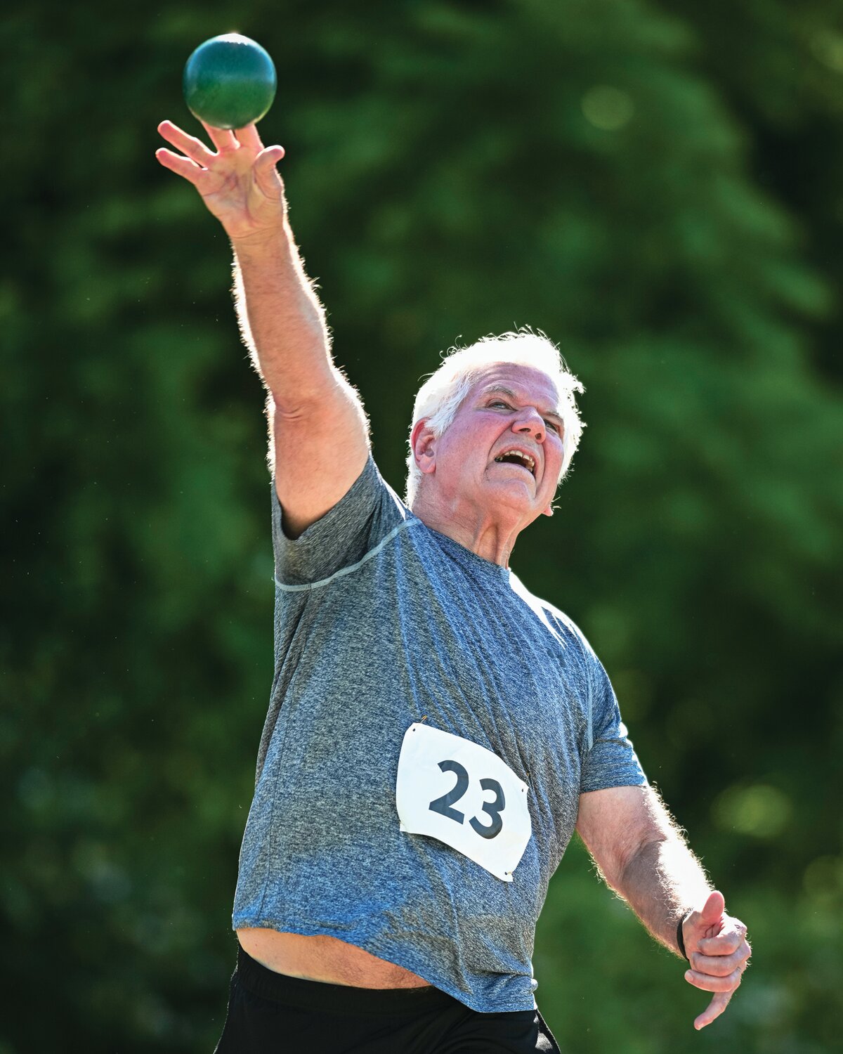 John Schwartz,63, lets loose during the shot put.