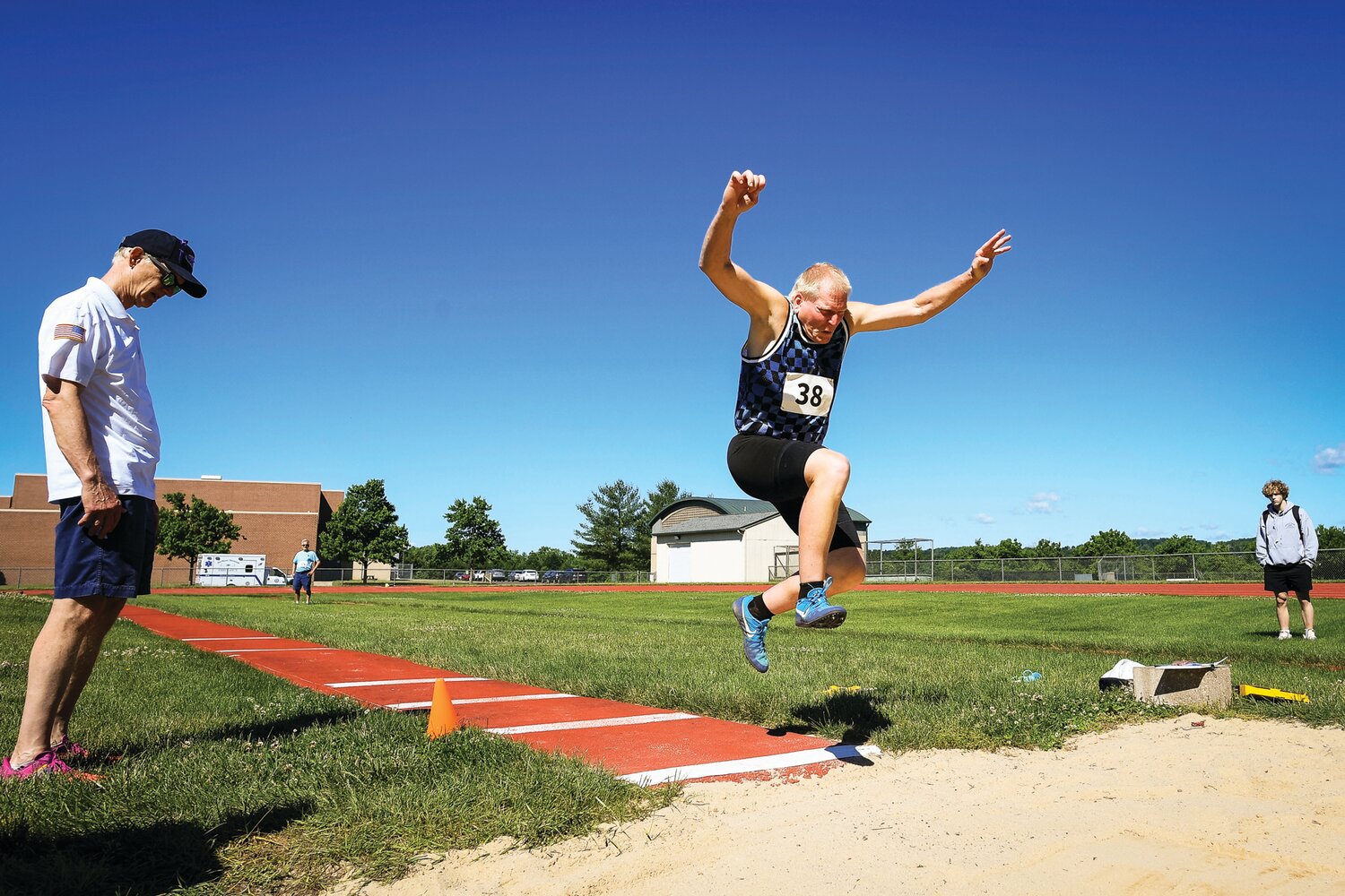 Peter Merena jumps 7 feet, 9 inches in the long jump.